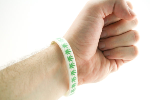 Rubber Wristband White Background with Green Cannabis Leaves all Around
